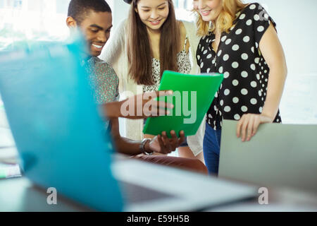 People using digital tablet together in office Stock Photo