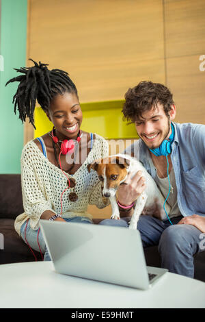 People and dog working in office Stock Photo