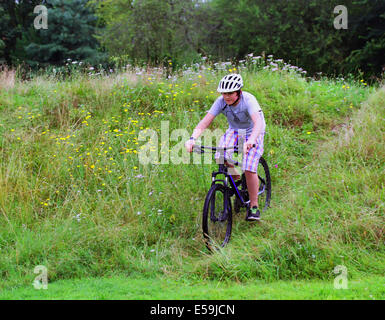 Teenage boy riding on the bike in the park Stock Photo