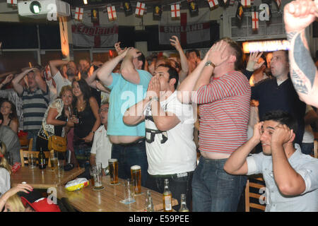 England football fans celebrate an England goal whist watching a world cup match against Italy in the Boomerangs bar,Plymouth Stock Photo