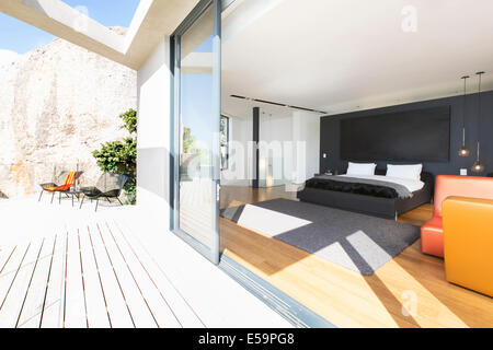 Sliding glass door onto bedroom in modern house Stock Photo