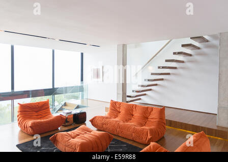 Sofas and staircase in modern living room Stock Photo