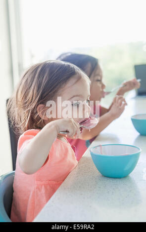 Sisters eating breakfast together Stock Photo