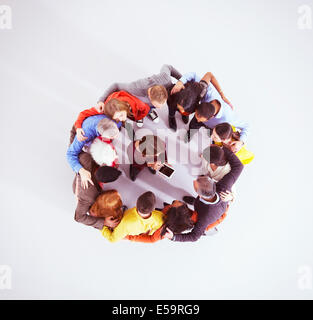 Business people huddled around woman with digital tablet Stock Photo
