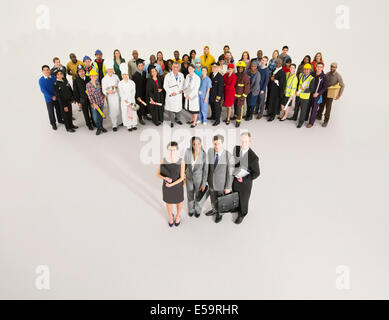 Workforce behind confident business people Stock Photo