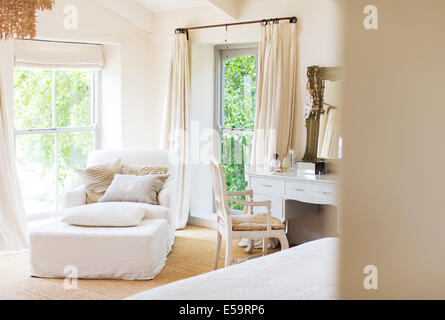 Armchair and vanity in rustic bedroom Stock Photo