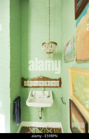 Sink and chandelier in rustic bathroom Stock Photo