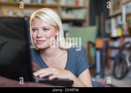 Woman using laptop in study Stock Photo
