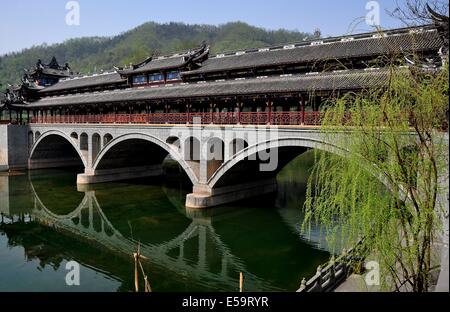 JIE ZI ANCIENT TOWN (SICHUAN), CHINA:  The handsome Ruilong covered bridge with its three large spans and decorative roofs Stock Photo