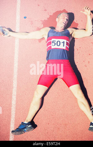 Runner laying on track Stock Photo