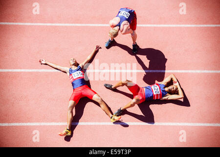Runners collapsing on track Stock Photo