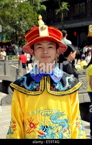 JIE ZI ANCIENT TOWN, CHINA:  Young man wearing rented vintage clothing poses for photos in the Wastepaper Pagoda Square Stock Photo