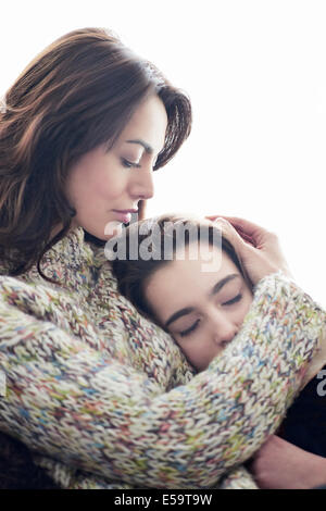 Mother hugging daughter Stock Photo