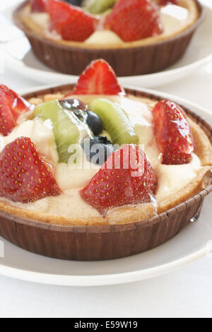 Fruit tarts made with sweet pastry crème pâtissière and fruit Stock Photo