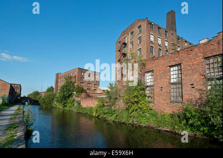 Two old warehouses by the side of the Ashton canal in Ancoats, Manchester, UK. Stock Photo