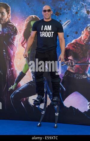 Actor Vin Diesel on stilts attends the European Premiere of Guardians of the Galaxy on 24/07/2014 at Empire Leicester Square, London. Vin used the stilts on set to atain the height of the CGI character Groot that he plays in the film. Persons pictured: Vin Diesel. Picture by Julie Edwards Stock Photo