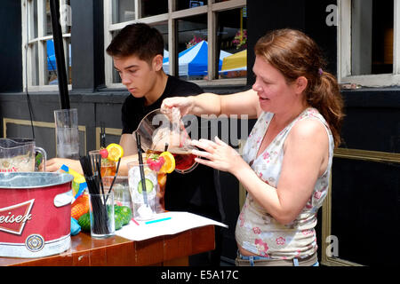 two people selling pimms cocktails outside of a pub at the southsea food fair festival 2014 england uk Stock Photo