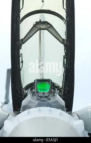 Front view of the open cockpit of a fighter jet with green head-up display. Stock Photo