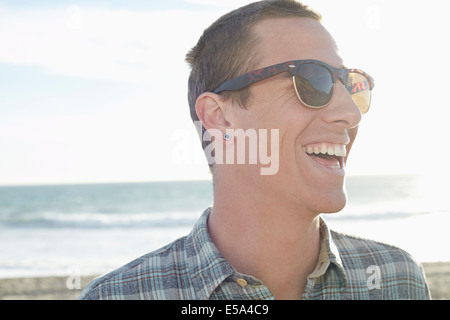 Caucasian man laughing on beach