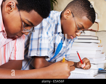 Mixed race boys doing their homework Stock Photo