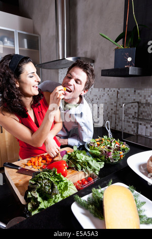 Couple cooking together in kitchen Stock Photo