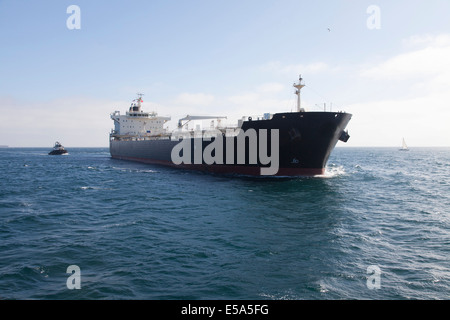 Oil tanker with tugboat at sea Stock Photo