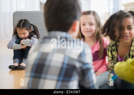 Children excluding girl in group Stock Photo