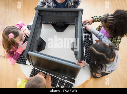 Children using computers in classroom Stock Photo