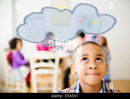 Boy with thought bubble over his head Stock Photo