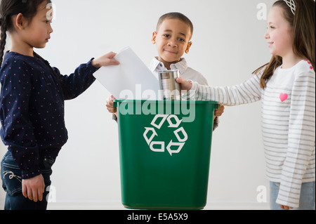 Children recycling together Stock Photo