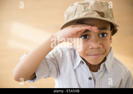 African American boy giving salute Stock Photo