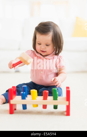Hispanic toddler with Down syndrome playing Stock Photo