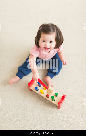 Hispanic toddler with Down syndrome playing Stock Photo