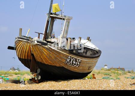 Clinker built fishing boat on shingle beach at Dungeness, Kent, England, UK Stock Photo