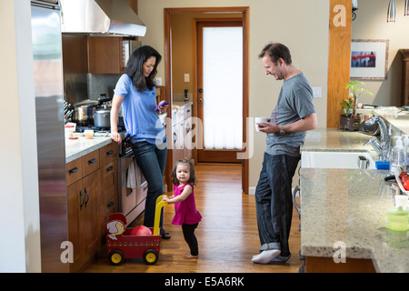 Family relaxing in kitchen Stock Photo