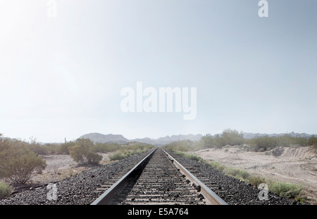 Train tracks in dusty rural landscape Stock Photo