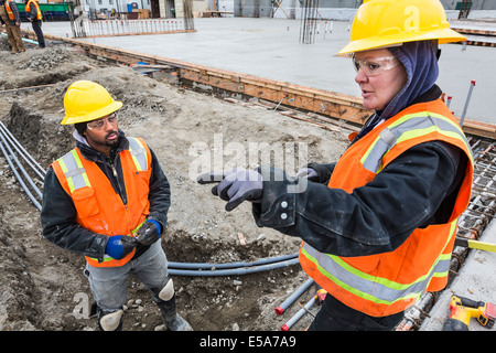 Workers talking at construction site Stock Photo