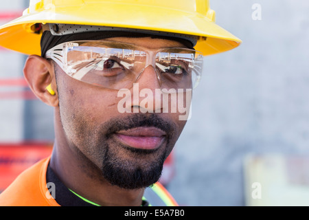 Black worker smiling on construction site Stock Photo
