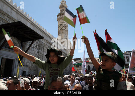 Damascus, Syria. 25th July, 2014. Syrian and Palestinian people gather at the Hamidiyah Market in the old city of Damascus, Syria, July 25, 2014, to commemorate the Jerusalem Day (Quds Day). The event was called for by Damascus-based Palestinian groups. Jerusalem Day was started by the late Ayatollah Khomeini, founder of the Islamic Iranian Republic, who called on the world's Muslims to show solidarity with Palestinians on the last Friday of the fasting month of Ramadan. Credit:  Bassem Tellawi/Xinhua/Alamy Live News Stock Photo