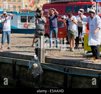 Finland's Unscientific Society throws a Cold Stone at Helsinki’s South Harbour in Finland Stock Photo