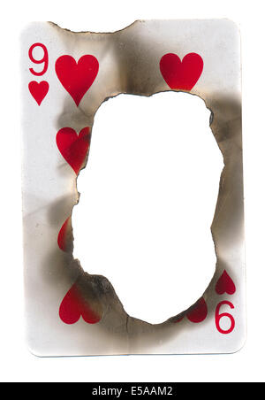 burn hole in old dirty playing card of hearts paper background. Isolated on white Stock Photo