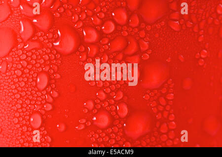 Water drops on red background Stock Photo - Alamy