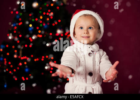 Santa little girl playing in snowflakes, Debica, Poland Stock Photo