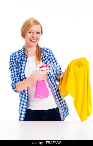 Perfect housewife cleaning the stain with shirts, Debica, Poland Stock Photo