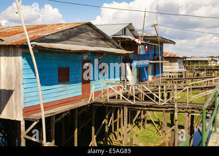 Houses on stilts rise above the polluted water in Islandia Peru Stock Photo