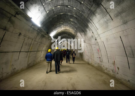 Mauthausen,Austria-May 10,2014:people with helmet visit the Gusen tunnel,a serie of secret tunnels near the concentration camp o Stock Photo