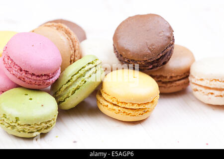Typical French macaroons biscuits on wooden table Stock Photo
