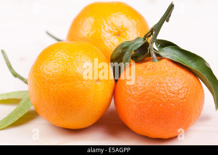 three Clementine on the wooden table Stock Photo