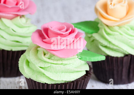 cupcakes decorated with pink and ivory roses Stock Photo