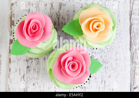 three cupcakes decorated with roses Stock Photo